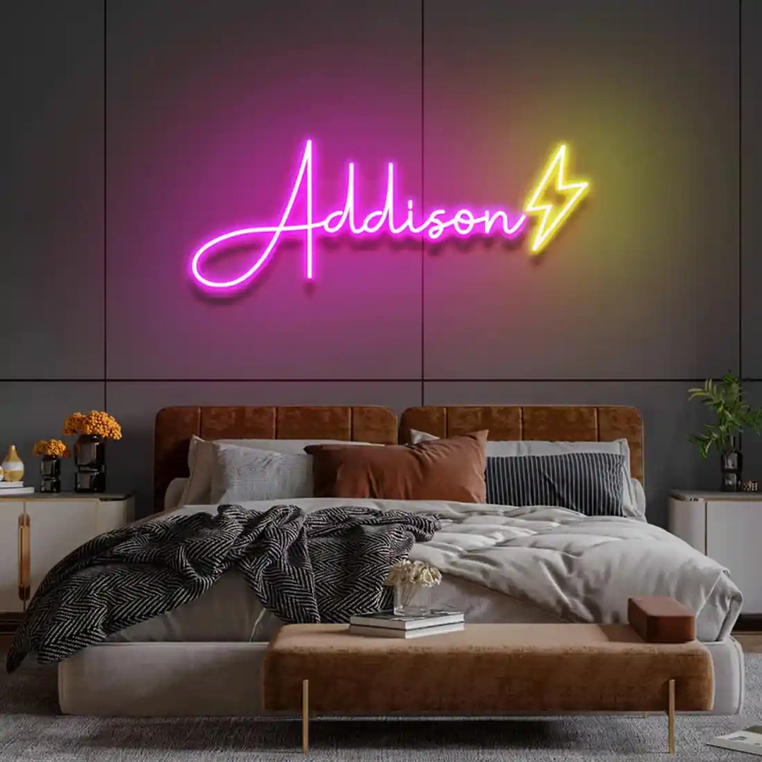 Pink Adison neon name sign glowing against a dark background